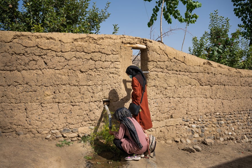 Two girls take refreshment after class