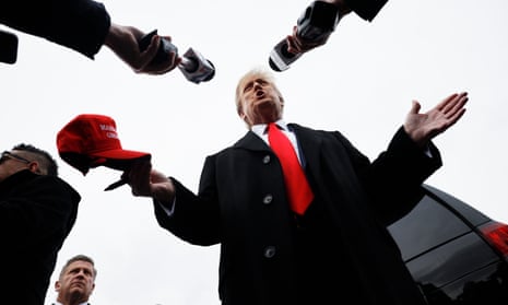Donald Trump talks to reporters while visiting a polling site at Londonderry High School yesterday.