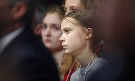 Swedish environmental activist Greta Thunberg listens as U.S. President Donald Trump addresses the World Economic Forum in Davos, Switzerland, Tuesday, Jan. 21, 2020. The 50th annual meeting of the forum will take place in Davos from Jan. 21 until Jan. 24, 2020. (AP Photo/Markus Schreiber)