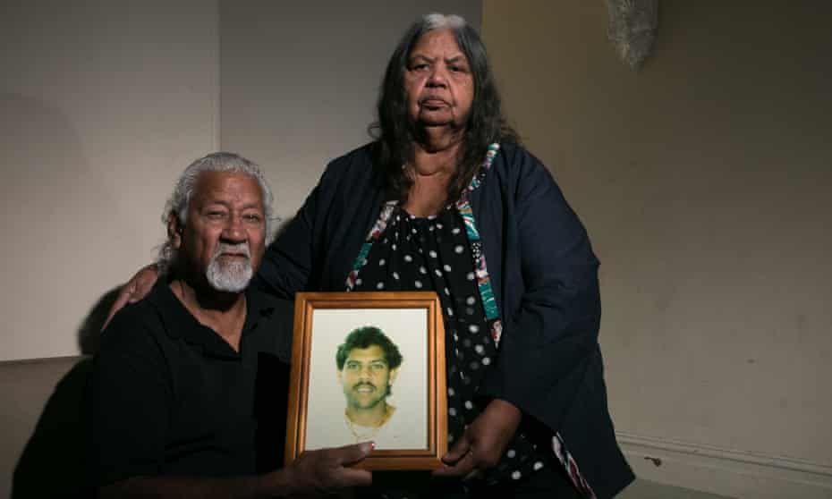 Ted and Helen Russell with a photo of their son Edward, who died in a New South Wales jail in 1999.