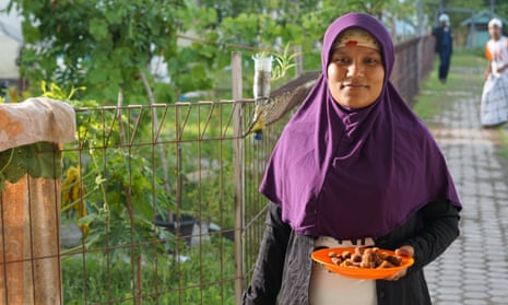 A Rohingya woman, Fatima Khatu, holds tamarind fruits gathered in a refugee camp in Bireuen