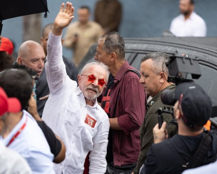 Brazilian President and presidential candidate Luiz Inácio Lula da Silva greets supporters after casting his ballot