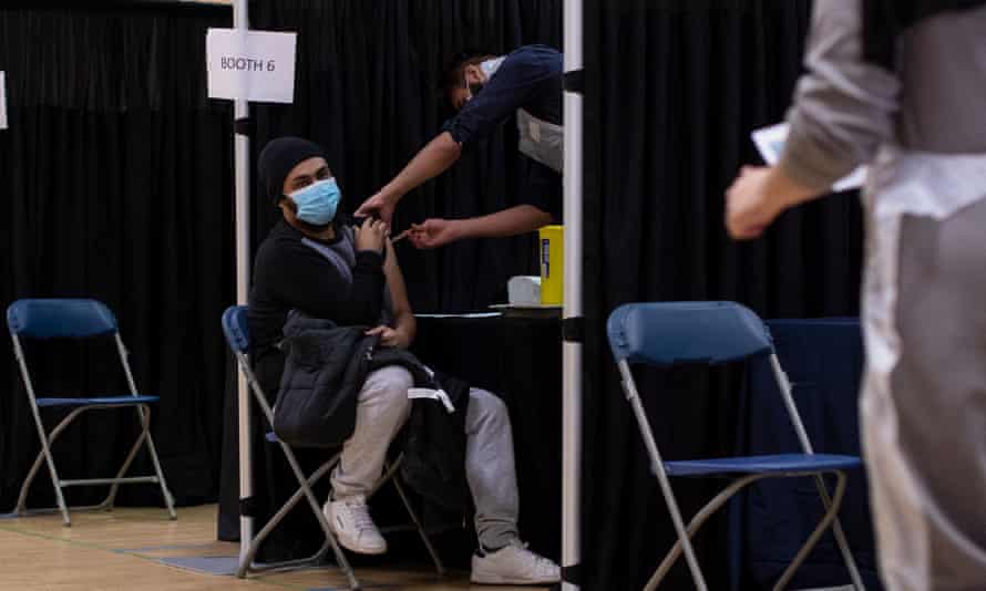 A man receives the AstraZeneca jab at the East London Mosque.