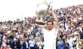 Andy Murray lifts the trophy after retaining his Queen’s Club title by beating Milos Raonic in three sets.
