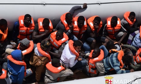 The Italian navy rescues a group of people off the coast of Libya.