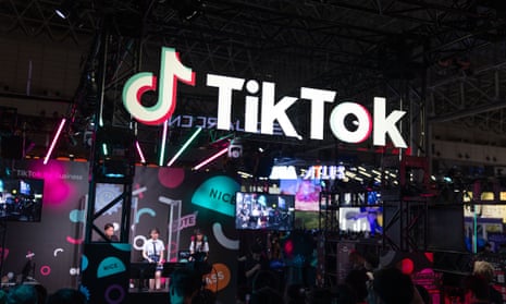 A stand with multiple screens topped by a brightly lit TikTok logo