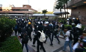 A large group of anti-government protesters try to find safe passage out of Hong Kong Polytechnic University and dodge police in Hung Hom district of Hong Kong on November 18, 2019
