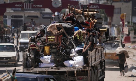 A truck loaded with household belongings heads for the exit of Maghazi refugee camp.