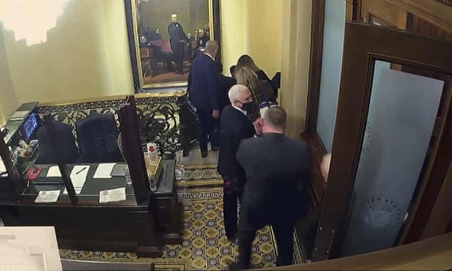 A still from a security video shows Mike Pence being evacuated as rioters breach the US Capitol.