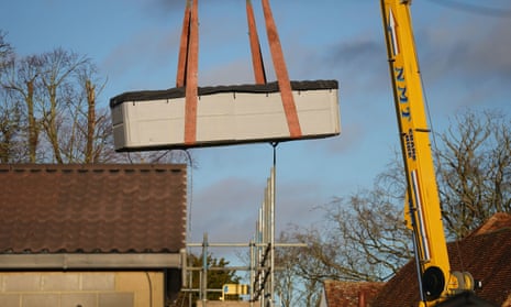 Crane lifts masonry out of property