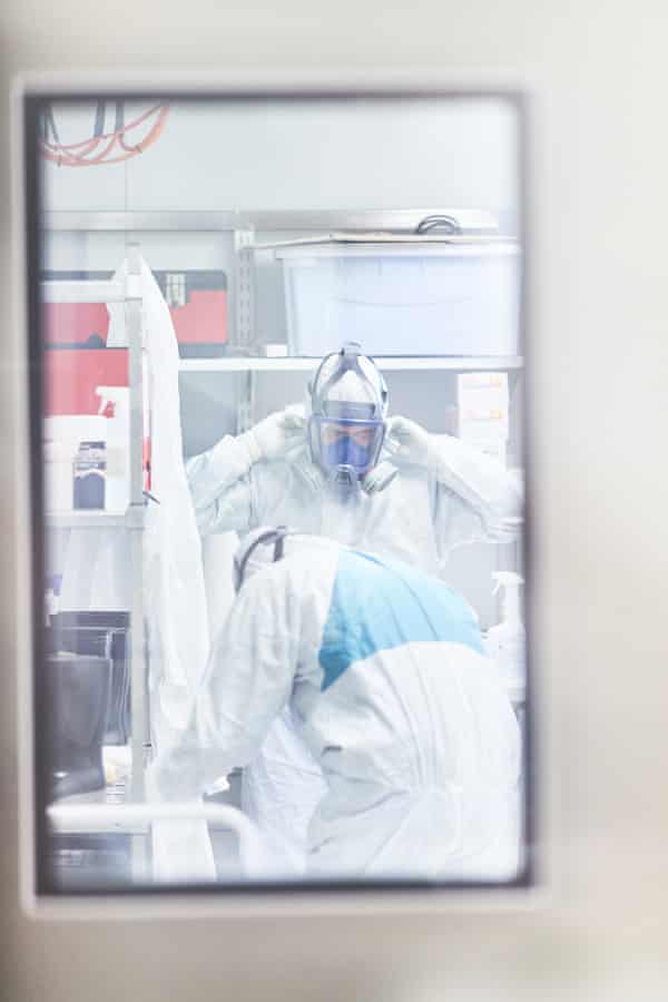 Along the way through each chamber, the researchers put on more layers of personal protective equipment.