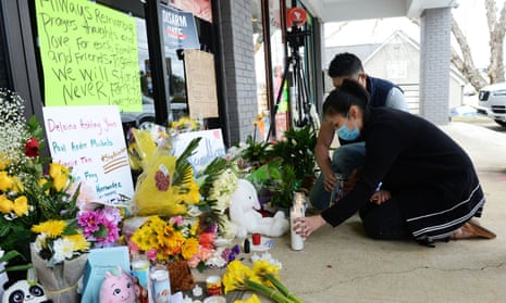 Jami Webb and her fiance, Kevin Chen, light candles outside Young’s Asian Massage. Webb is the daughter of Xiaojie Tan, who was killed in the Atlanta shootings. 