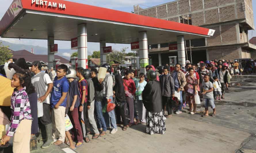 Basic supplies are running low. People queue up for petrol in Palu on Sunday.