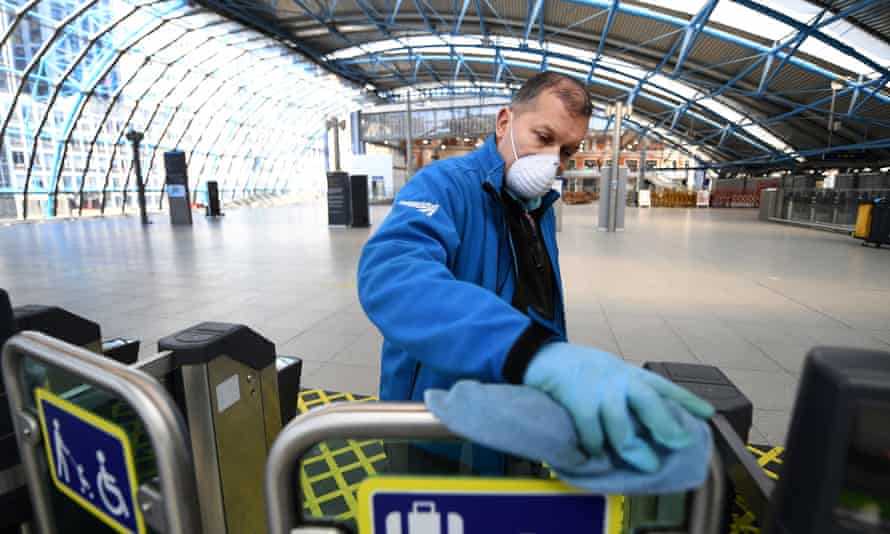 A member of Network Rail staff clears ticket barriers at Waterloo station in London.