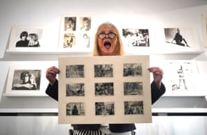 Model and photographer Pattie Boyd holds up photos she took of the Beatles during a trip to India