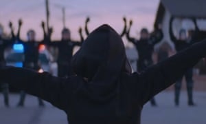 A little boy who had been dancing for helmeted police officers receives their answer, during the video for Beyoncé's new single Formation.