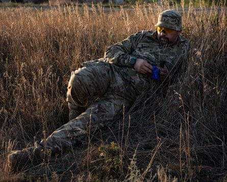 A member of the Platzdarm team takes a break from his painstaking work, lying among the long grass.