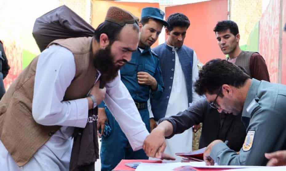 Afghan security forces register the release of Taliban prisoners in Kabul