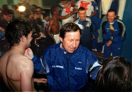 Auxerre’s coach Guy Roux (C) congatulates his players at the end of their match against Guingamp in May 1996. Auxerre secured their first championship title with a 1-1 draw to win the first league and cup double since Marseille in 1989.