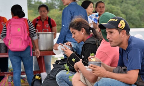 Venezuelans wait at the binational border attention centre in Huaquillas, Ecuador on the border with Peru. 
