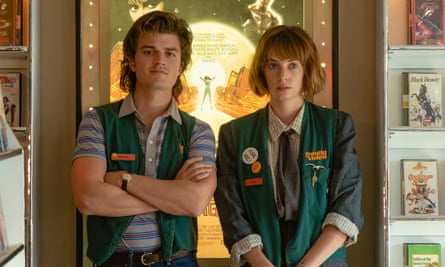 young man and woman wearing matching green vests