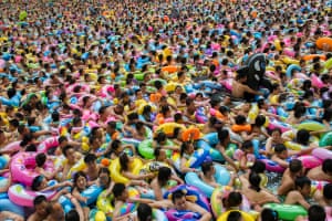 People enjoying a crowded swimming pool, Sichuan, China.