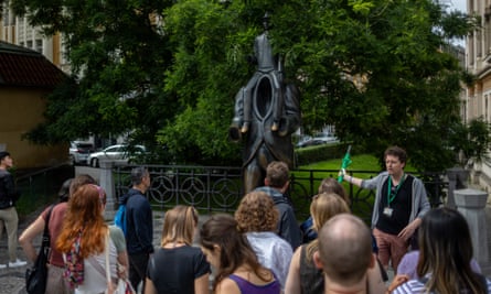 Tourists gather in front of statue of Franz Kafka installed by sculptor Jaroslav Rona in 2003, in the Jewish Quarter of Prague.