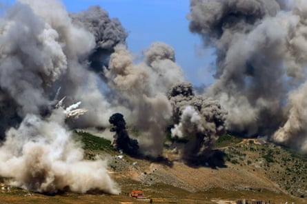 A whole hillside is covered in smoke from recent strikes