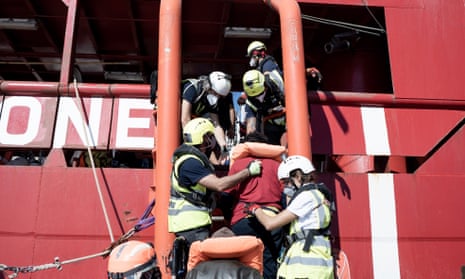 The vessel Ocean Viking, seen here rescuing people stranded in international waters, has more than 200 people onboard.