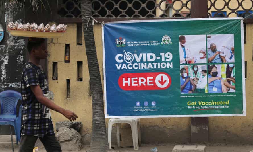 A man walks past a Covid-19 vaccination banner pasted in front of a clinic in in Lagos in December last year.