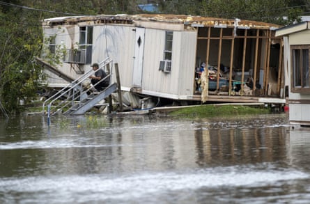 Surrounded by floodwater, a homeowner sits on his front steps after Hurricane Ida destroyed part of the mobile home near LaPlace, near New Orleans, on Monday.