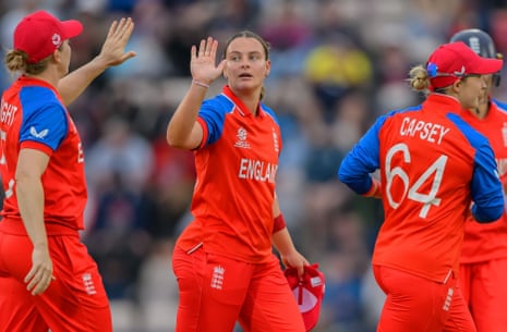 Dani Gibson of England (centre) celebrates taking the wicket of Alice Tector of Ireland with her teammates.
