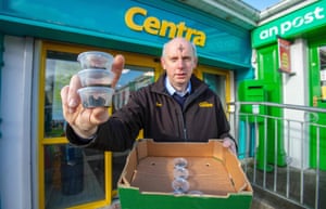Joe Joyce with takeaway pots of ashes outside his shop in Clonmany, Co Donegal, Ireland