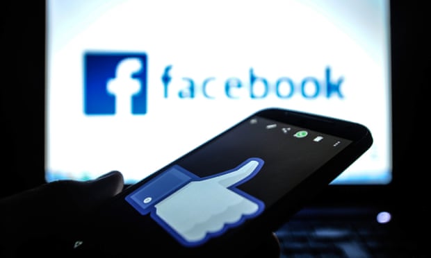 A smartphone and a computer screen with the Facebook logo