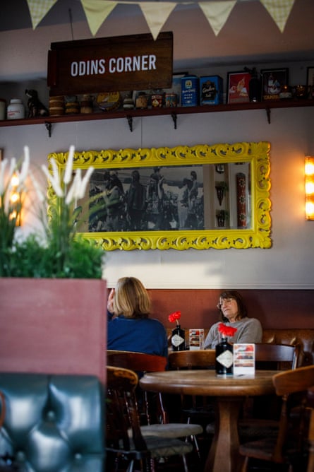 Two women sitting at a pub table having a conversation
