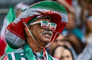 An Iran fan in green white and red hat, sunglasses and shirt