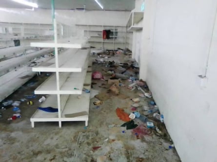 The shelves of Rahman’s shop, entirely emptied of goods after looting.
