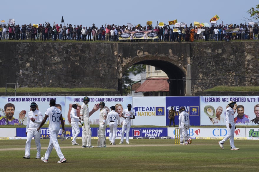 Sri Lanka’s Test team look to future as Australia briefly slip back into past | Cricket 5 Anti-government protesters demonstrate from the 17th-century Dutch fort during the second day of Sri Lanka’s second Test against Australia in Galle.