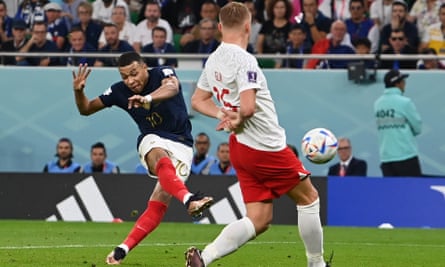 Kylian Mbappé shoots the ball past Poland’s Kamil Glik to score his first goal