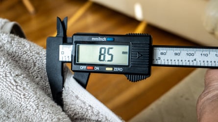 The thickness of a Quince Ultra-Plush being taken with calipers.