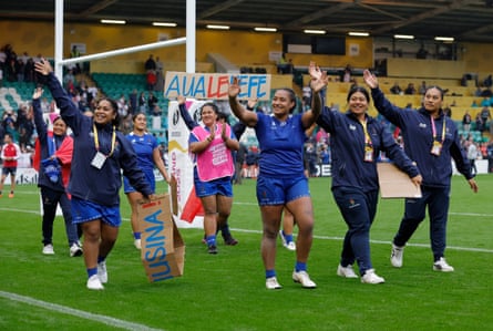 Samoa players wave to the crowd on a lap of honour after the defeat to England.