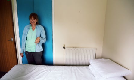 Christine Hughes helps prepare a double bed before the family arrives.