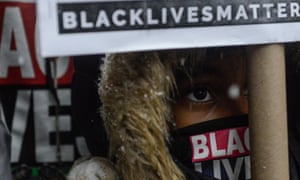 People participate in a Black Lives Matter protest in front of Trump Tower in New York City on 14 January 2016.