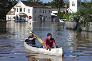 Residents canoe through floodwater in the aftermath of Hurricane Ida in Manville