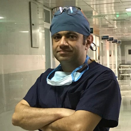A middle-aged man of Middle Eastern appearance, dressed in surgery uniform