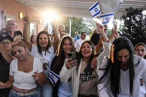 Relatives and friends Alon Ohel celebrate as they watch news broadcasts related to his release