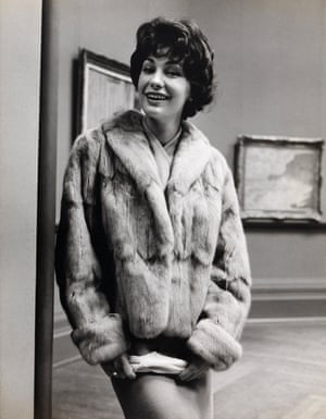 Fashion illustration with model wearing a hip-length fur jacket, photographed at the National Gallery of Victoria in Melbourne (1960s).