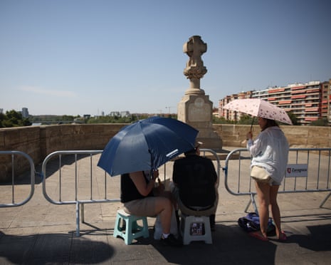 People prepare to watch total solar eclipse from Puente de Piedra bridge in Saragossa, Spain.
