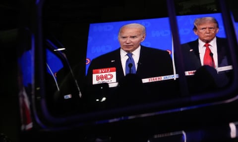 A car door reflects Joe Biden and Donald Trump, both men wearing suits and looking ahead 