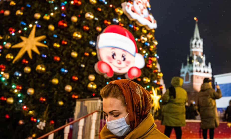 A woman walks past Christmas decorations in Red Square, Moscow.
